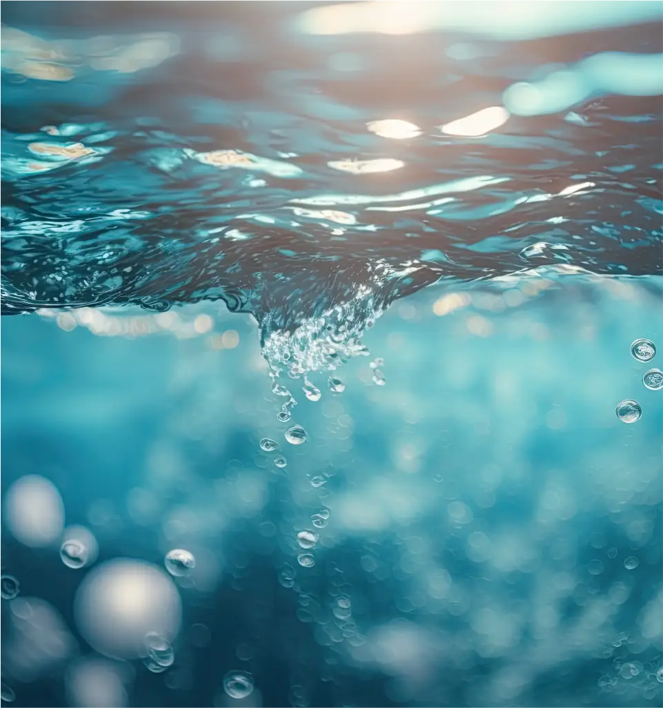 A decorative photo of some water as seen by a camera half submerged
